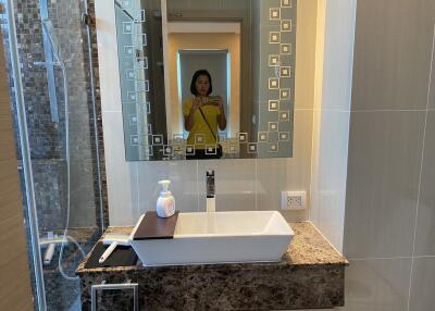 Modern bathroom with large mirror and sink countertop
