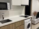 Modern kitchen with wooden cabinets and white countertop, featuring appliances