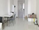 Modern living area with dining table and white furniture