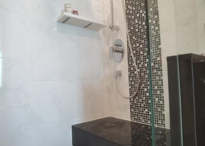 Modern shower area with bench