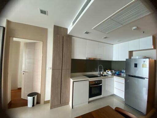 Modern kitchen with white cabinets and stainless steel appliances