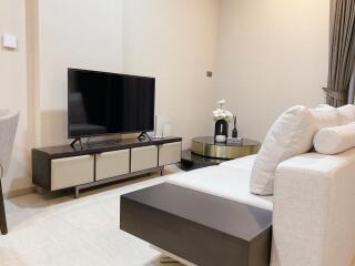 Modern living room with sofa, TV, and coffee table