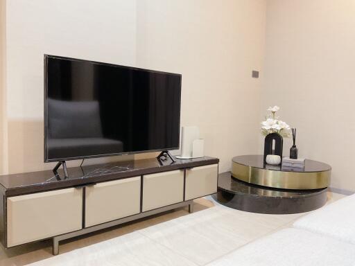 Modern living room with a large television and stylish decor