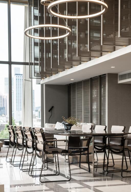 Modern dining area with contemporary lighting and seating arrangement