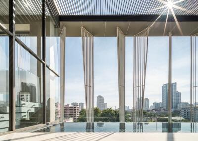 Modern high-rise building with city view and pool