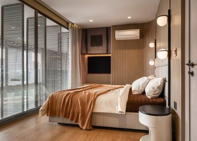 Modern bedroom with large windows and bedside lighting