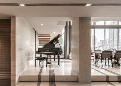 Elegant living area with grand piano and dining space