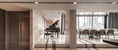 Elegant living area with grand piano and dining space