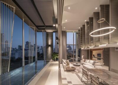 Elegant modern living area with city view, stylish lighting, and an infinity pool