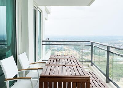 Spacious balcony with wooden furniture and scenic view