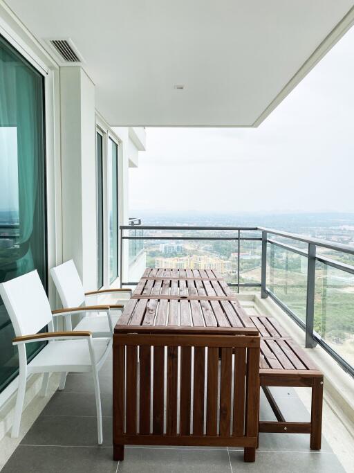 Spacious balcony with wooden furniture and scenic view