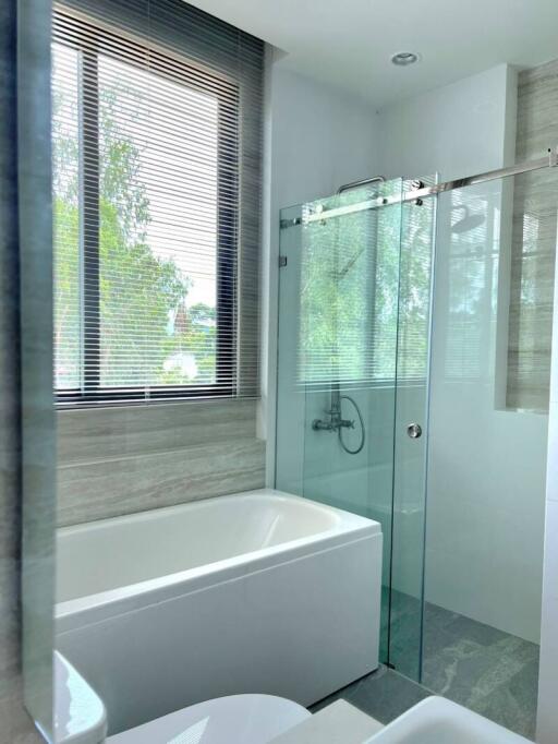 Modern bathroom with bathtub and glass shower enclosure