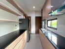 Modern kitchen with wooden cabinets and black countertops