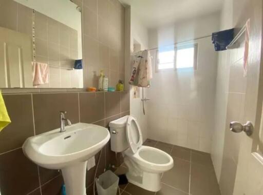 Modern bathroom with sink, mirror, toilet, and shower area