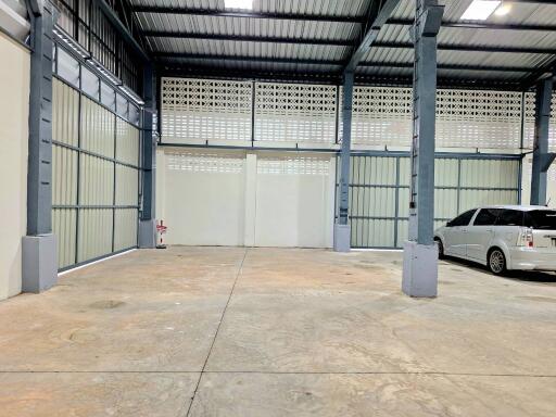 Spacious garage with ample room and a parked car