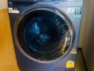 Modern front-loading washing machine in a laundry room