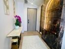 Modern hallway with a decorative console table, luxurious shelving, and a door