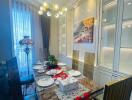 Elegant dining room with modern chandelier and set table