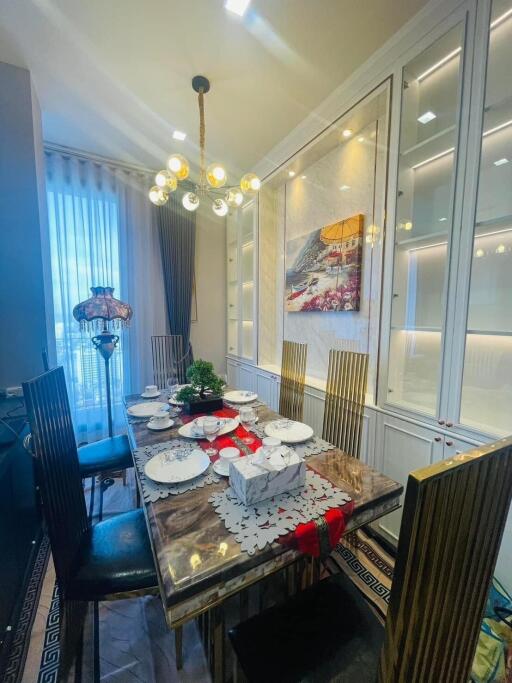 Elegant dining room with modern chandelier and set table