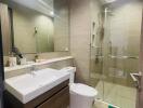 Modern bathroom with glass shower and large mirror