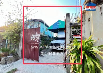 View of house entrance with a car and garden