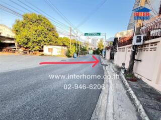 Street view of the neighborhood with nearby buildings and greenery.