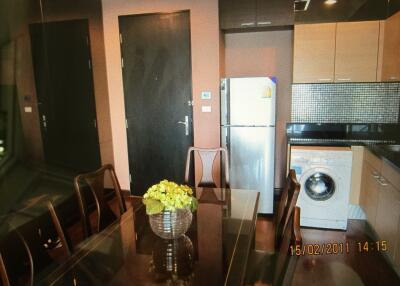 Kitchen and dining area with table, chairs, and appliances