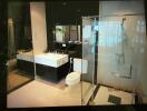 Modern bathroom with glass shower, large sink, and toilet