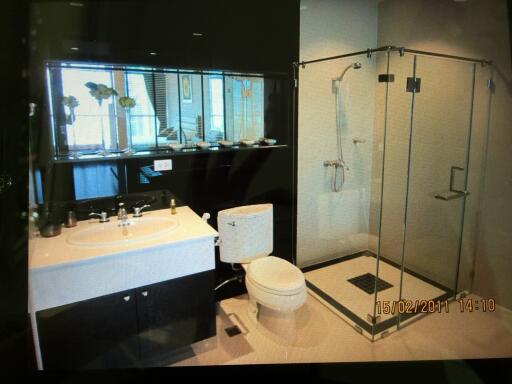 Modern bathroom with glass shower and large mirror