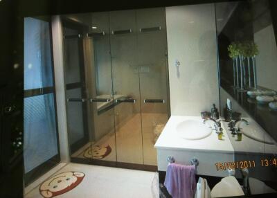 Bathroom with glass shower, vanity, and decorations