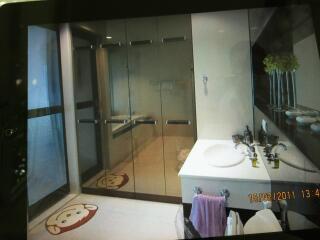 Bathroom with glass shower, vanity, and decorations