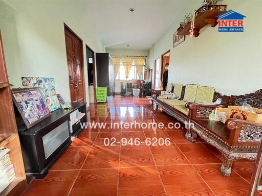 Spacious living room with wooden furniture and large windows