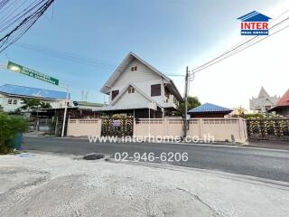 Two-story house with a gated driveway