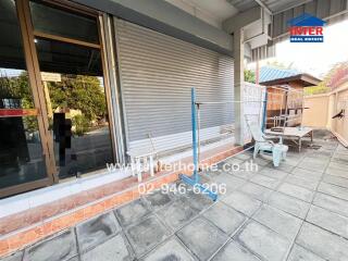 Outdoor seating area with tiled flooring and metal fencing