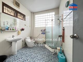 A well-appointed bathroom with a shower, toilet, sink, and various toiletries