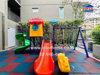 Colorful playground area with slides and swings