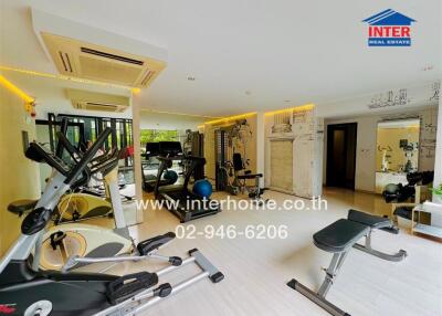 Well-equipped gym room with various exercise machines and fitness equipment