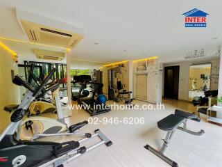 Well-equipped gym room with various exercise machines and fitness equipment