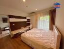 Spacious bedroom with large window and built-in storage