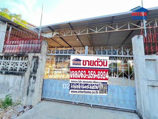 Front view of the building with a gate and 