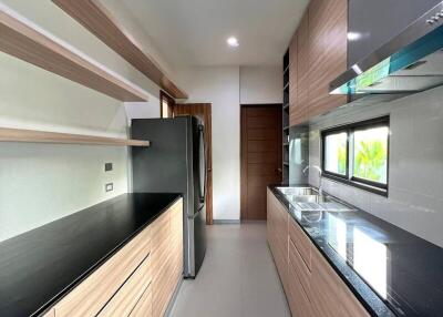 Modern kitchen with wooden cabinets and black countertops