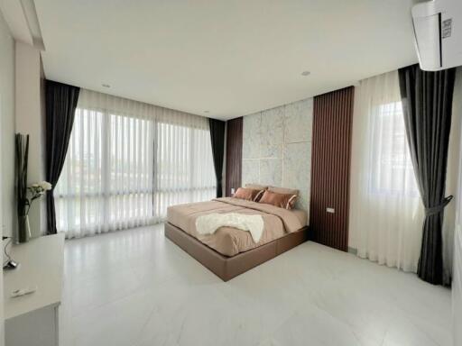 Modern bedroom with large windows