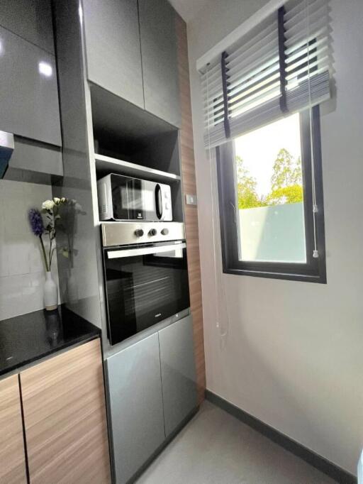Modern kitchen with built-in appliances and large window