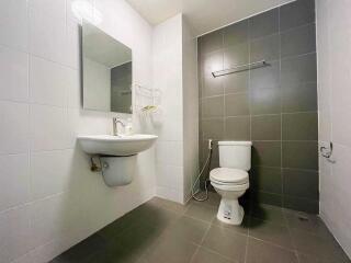 Modern bathroom with sink, mirror, and toilet