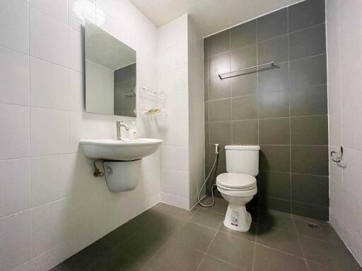 Modern bathroom with sink, mirror, and toilet