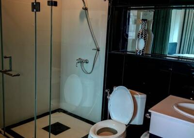 Modern bathroom with glass shower enclosure and white fixtures