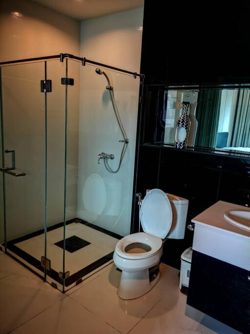 Modern bathroom with glass shower enclosure and white fixtures