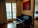 Modern living room with wooden flooring and balcony view