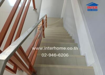 Staircase with railing and website details