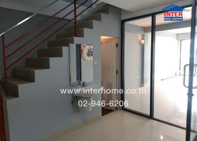 Staircase area with glass doors and bathroom entrance
